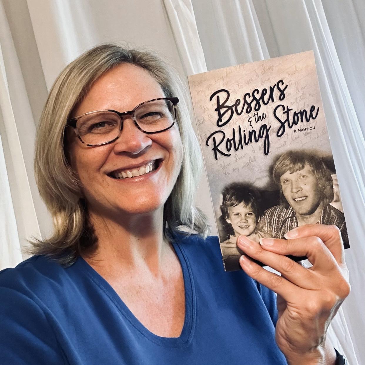 Gina Davidson holds her new book “Bessers & the Rolling Stone: A Memoir.” She described her father as a "rolling stone" in life who only ever called her "Bessers," a nickname sparked from her cousin not being able to pronounce her middle name Beth.