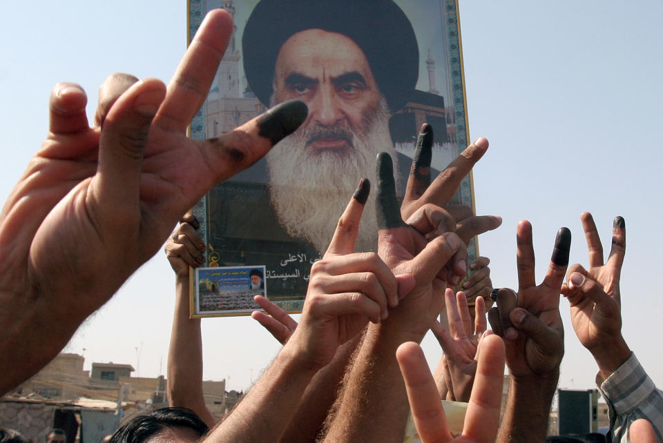 Image: Iraqi Shiites flash victory signs (Karim Kadim / AP file)