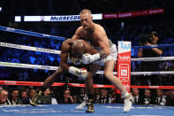 <p>(L-R) Floyd Mayweather Jr. throws a punch at Conor McGregor during their super welterweight boxing match on August 26, 2017 at T-Mobile Arena in Las Vegas, Nevada. </p>