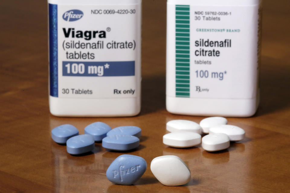 This Monday, Dec. 4, 2017 photo shows Pfizer's Viagra, left, and the company's generic version, sildenafil citrate, at Pfizer Inc., headquarters in New York. The drugmaker is launching its own cheaper generic version of Viagra rather than lose sales when its impotence pill gets its first generic competition. (AP Photo/Richard Drew)