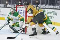 Vegas Golden Knights left wing William Carrier (28) looks to shoot against Minnesota Wild goaltender Cam Talbot (33) during the second period of an NHL hockey game Wednesday, March 3, 2021, in Las Vegas. (AP Photo/John Locher)