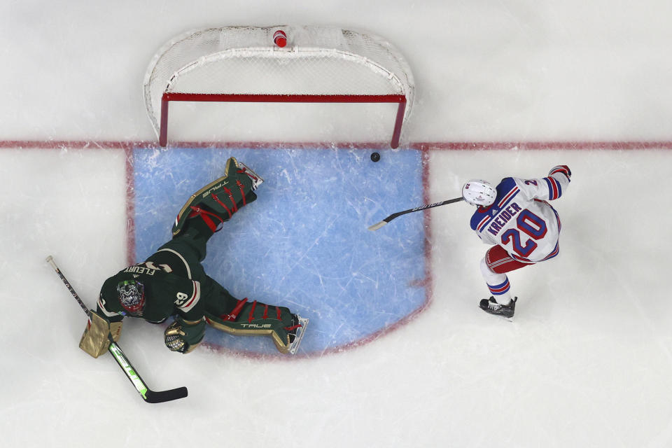 New York Rangers left wing Chris Kreider (20) scores a goal past Minnesota Wild goaltender Marc-Andre Fleury (29) during the first period of an NHL hockey game Thursday, Oct. 13, 2022, in St. Paul, Minn. (AP Photo/Abbie Parr)