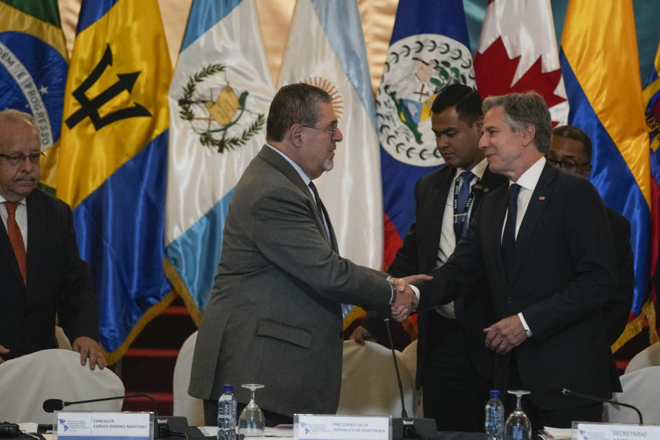 Guatemalan President Bernardo Arevalo, center, shakes hands with U.S. Secretary of State Antony Blinken at the National Palace in Guatemala City, Tuesday, May 7, 2024. Blinken is in Guatemala for a two-day visit where he will attend a regional meeting on irregular migration. (AP Photo/Moises Castillo)