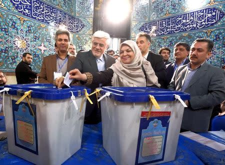 Iranian former vice president and candidate for parliamentary election Mohammad Reza Aref (2nd L) and his wife cast their ballots during elections for the parliament and Assembly of Experts, which has the power to appoint and dismiss the supreme leader, in Tehran February 26, 2016. REUTERS/Raheb Homavandi/TIMA