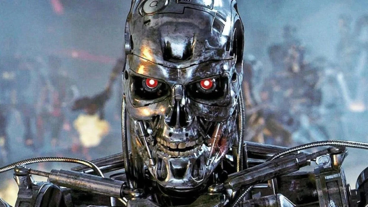  Still from a Terminator movie. A close up of a metal skull with piercing red eyes and teeth. In the background you can see a horde of metal skeletons firing big guns. 