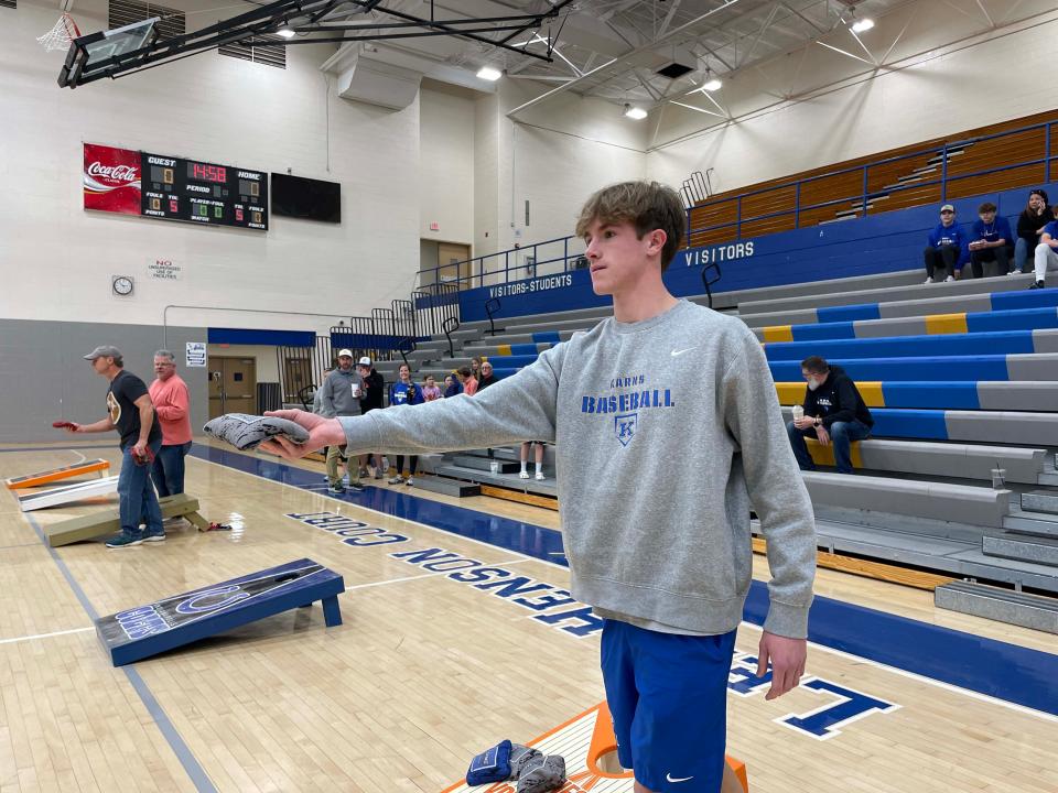 Owen Burnett, pitcher for Karns High School baseball, is warming up to deliver his best pitch during a cornhole tournament Dec. 17, 2023.