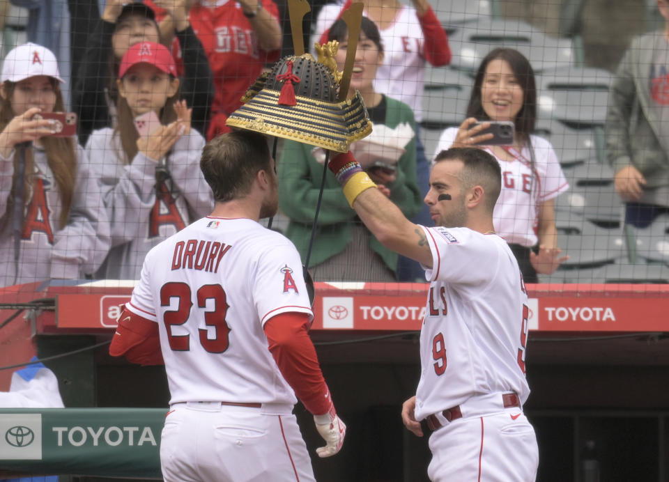 Los Angeles Angels shortstop Zach Neto (9) congratulates Los Angeles Angels Brandon Drury (23) after a home run against the Oakland Athletics during the first inning of a baseball game Sunday, Oct. 1, 2023, in Anaheim, Calif. (AP Photo/John McCoy)