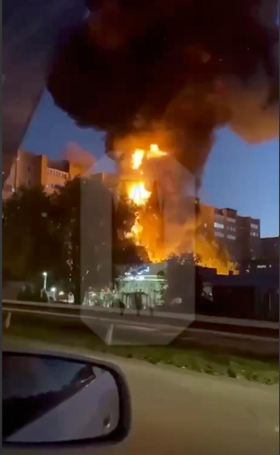 In this handout photo taken from video released by Ostorozhno Novosti, flames and smoke rise from the scene where a warplane crashed into a residential area in Yeysk, Russia, on Oct. 17, 2022.
