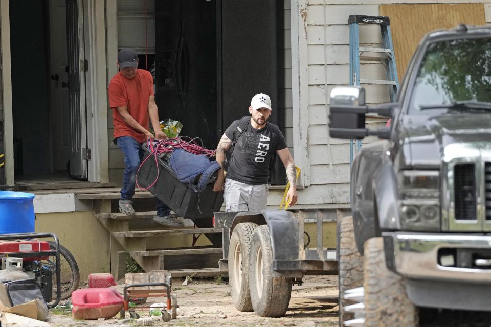Items are removed from the victim's home Tuesday, May 2, 2023, where a mass shooting occurred Friday, in Cleveland, Texas. The search for the suspected gunman who allegedly shot five of his neighbors, including a child, after they asked him to stop firing off rounds in his yard stretched into a fourth day Tuesday. (AP Photo/David J. Phillip)