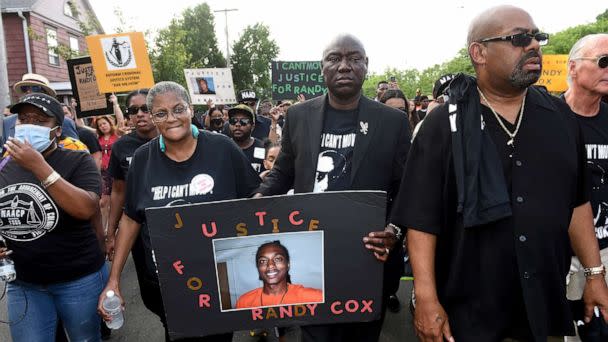 PHOTO: In this July 8, 2022, file photo, Doreen Coleman, mother of Richard 'Randy' Cox Jr., walks with civil rights attorney Benjamin Crump during a march for Justice for Randy Cox on Dixwell Avenue in New Haven, Conn. (Arnold Gold/New Haven Register via AP, FILE)