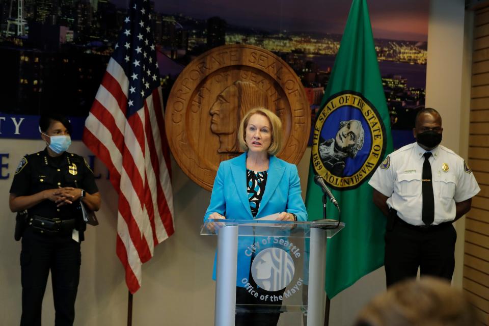 Seattle Mayor Jenny Durkan, center, speaks during a July 13 news conference at City Hall in Seattle as Police Chief Carmen Best, left, and Fire Chief Harold Scoggins , right, look on.