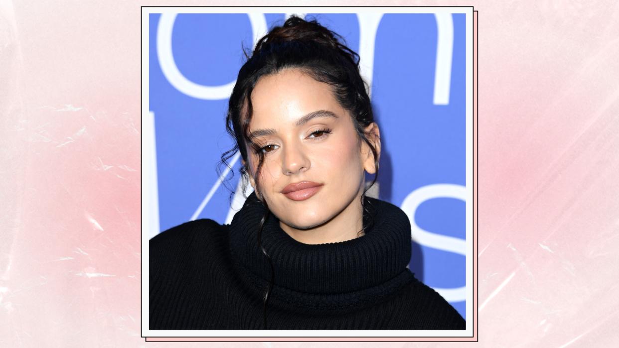  Rosalía wears a black top, and a nude glossy lip as she arrives at the 2023 Billboard Women In Music at YouTube Theater on March 01, 2023 in Inglewood, California/ in a pink and cream textured template 