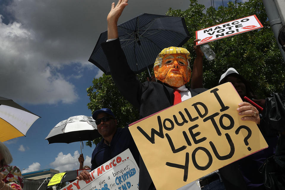 <p>Glenn Terry dressed as President Donald Trump joins with other protesters at U.S. Sen. Marco Rubio’s (R-FL) office on June 28, 2017 in Doral, Florida. (Photo: Joe Raedle/Getty Images) </p>