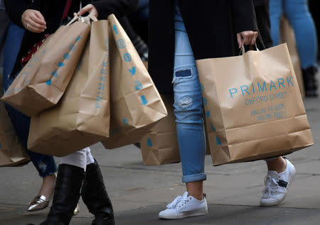 FILE PHOTO: Shoppers carry Primark bags in central London, Britain, November 3, 2017. REUTERS/Toby Melville/File Photo
