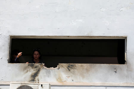 Women look out from a damaged house that was hit by a rocket fired from Gaza over the border to its Israeli side in a village next to the border, Israel May 4, 2019 REUTERS/Amir Cohen