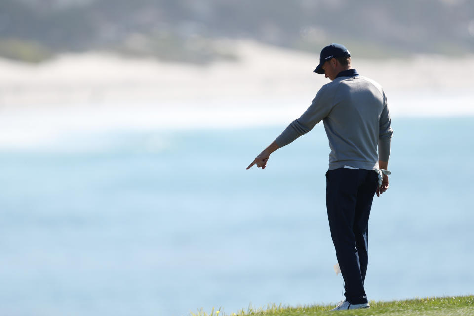 Jordan Spieth, pictured here assessing his extraordinary shot at Pebble Beach.