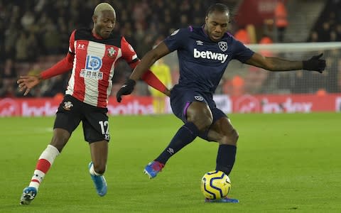 Michail Antonio of West Ham United in action with Moussa Djenepo of Southampton during the Premier League match between Southampton FC and West Ham United at St Mary's Stadium on December 14, 2019 in Southampton, United Kingdom - Credit: Getty Images