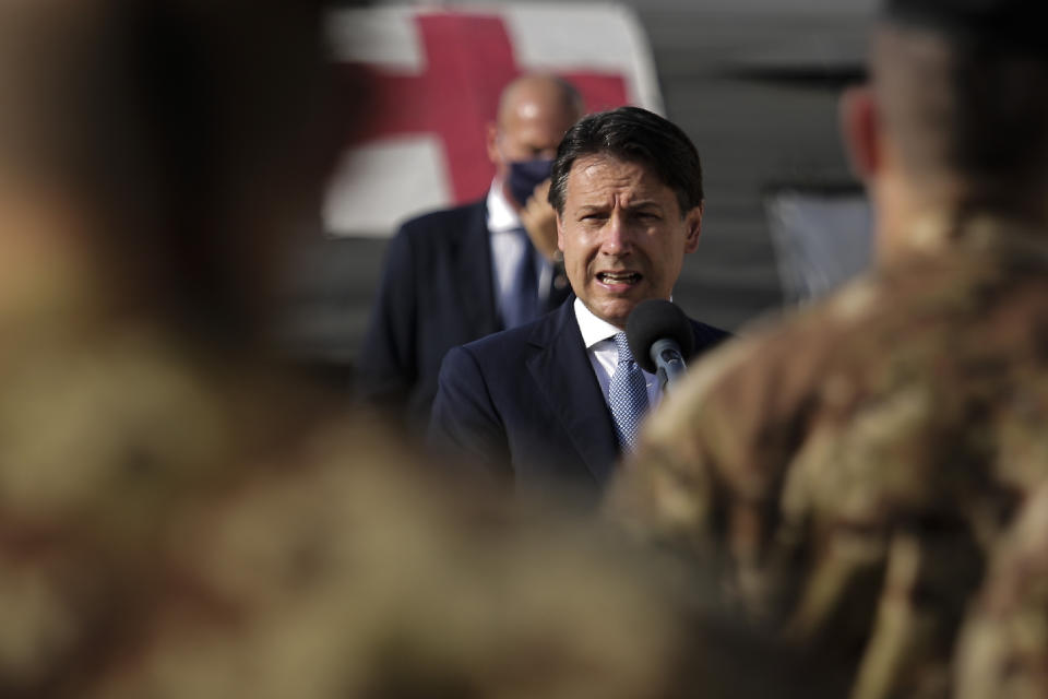 Italian Prime Minister Giuseppe Conte, center, addresses Italian soldiers as he visits an Italian field hospital set up at the Lebanese University in the Hadath district of Beirut, Lebanon, Tuesday, Sept. 8, 2020. Conte said Tuesday his country will support Lebanon's economic and social growth, expressing hopes that a new government is formed quickly — one that would start the reconstruction process in the wake of last month's Beirut explosion and implement badly needed reforms. (AP Photo/Hassan Ammar)