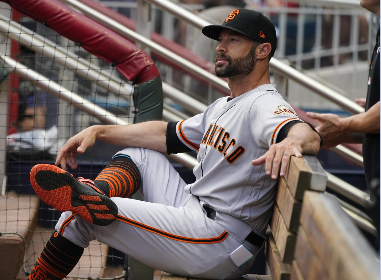 San Francisco Giants manager Gabe Kapler (19) sits on the bench as he waits for the first his team's baseball game against the Atlanta Braves to start Saturday, Aug. 28, 2021, in Atlanta. (AP Photo/John Bazemore)