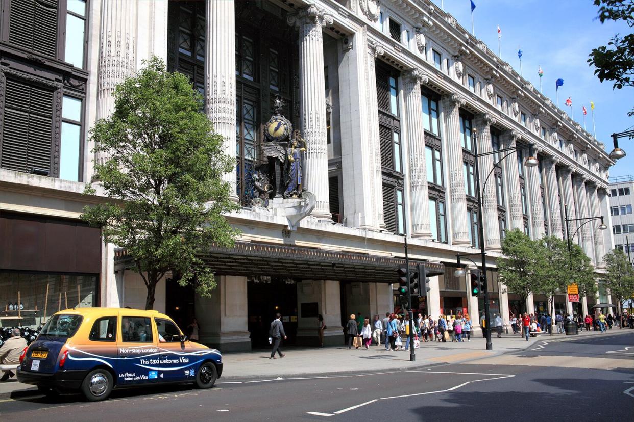 London, United Kingdom - May 1, 2011: Exterior of Selfridges department store in Oxford Street with a taxi in the foreground waiting for a customer.