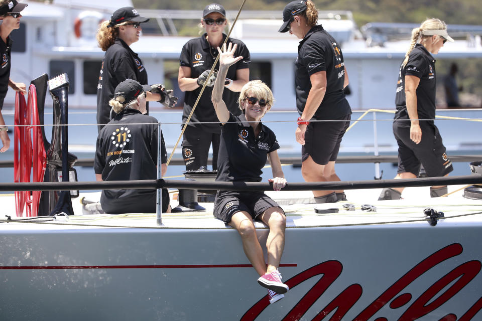 Former Australian Foreign Minister Julie Bishop, seated at center, waves before the start of the Sydney Hobart yacht race on board Wild Oats X in Sydney, Wednesday, Dec. 26, 2018. The 630-nautical mile race has 85 yachts starting in the race to the island state of Tasmania. (AP Photo/Rick Rycroft)