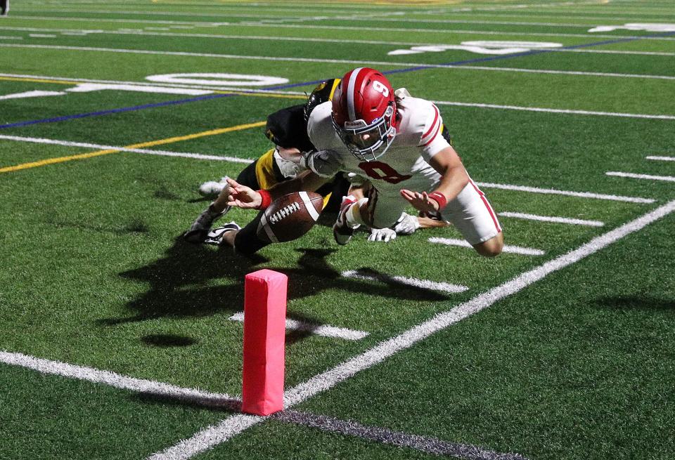 Fairport quarterback Jackson Rucker comes up short as he dives for the pylon against McQuaid.