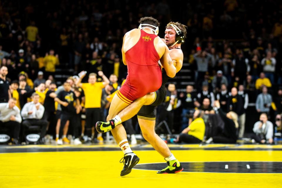 Iowa's Jacob Warner, right, wrestles Iowa State's Yonger Bastida at 197 pounds during a Cy-Hawk Series NCAA men's wrestling dual, Sunday, Dec. 4, 2022, at Carver-Hawkeye Arena in Iowa City, Iowa.