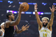 Los Angeles Clippers forward Kawhi Leonard, left, passes the ball as Golden State Warriors guard Ky Bowman defends during the first half of an NBA basketball game Friday, Jan. 10, 2020, in Los Angeles. (AP Photo/Mark J. Terrill)