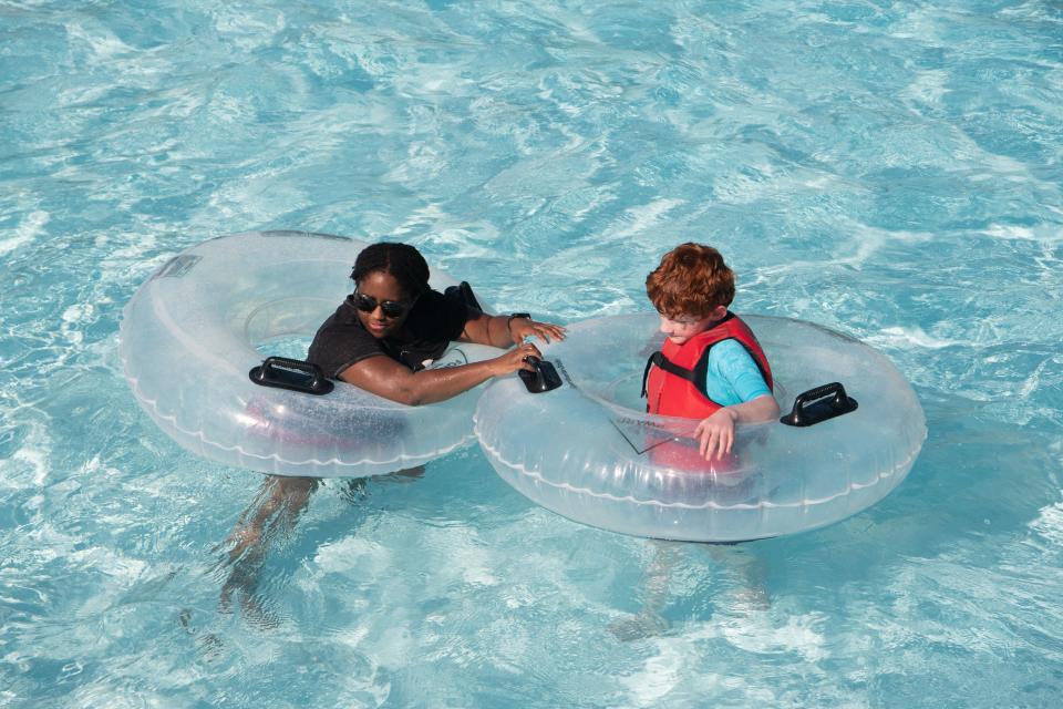 Brandi McCutcheon floats in the water with Isaac Moultrie, 10, at Nashville Shores in Nashville, Tenn., Thursday, June 20, 2024.