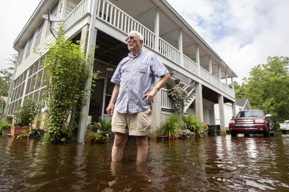 Charles Grainger cleans up around his house in the historic district of French Quarter Creek as flood waters recede from Tropical Storm Debby, Wednesday, Aug. 7, 2024, in Huger, S.C. (AP Photo/Mic Smith)