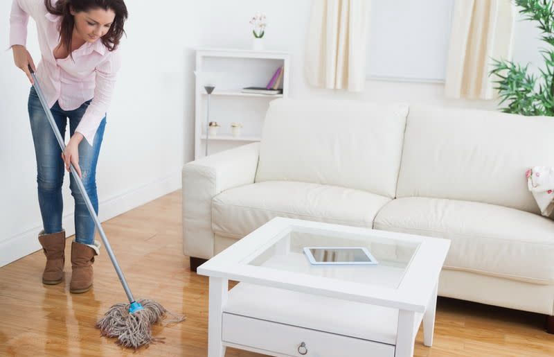 Woman mopping living room floor