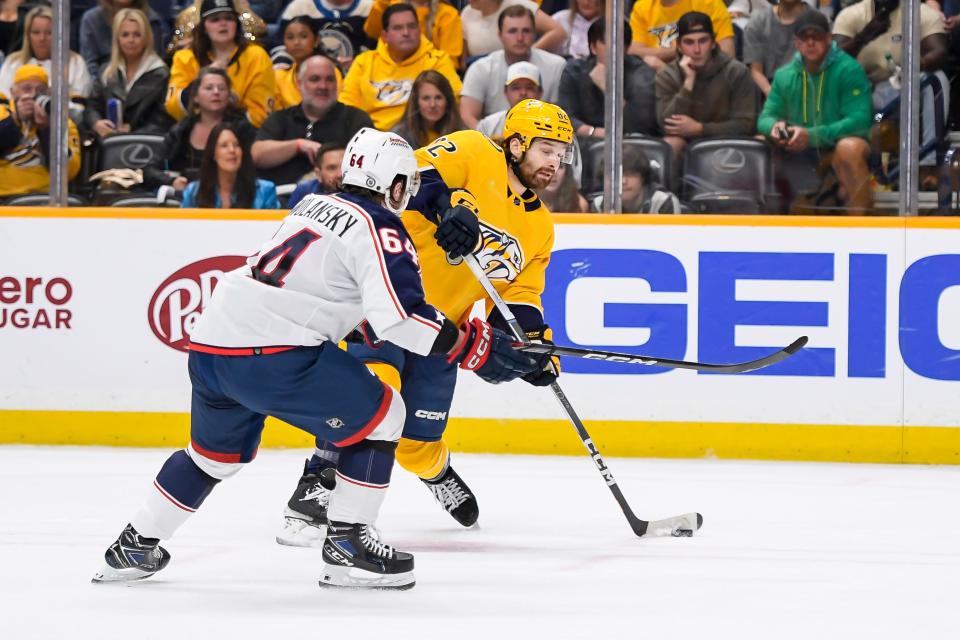 Apr 13, 2024; Nashville, Tennessee, USA; Nashville Predators center Tommy Novak (82) shoots and scores against the Columbus Blue Jackets during the first period at Bridgestone Arena. Mandatory Credit: Steve Roberts-USA TODAY Sports