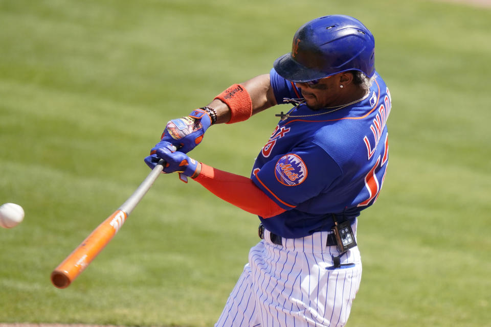 New York Mets' Francisco Lindor hits a single during the third inning of a spring training baseball game against the Houston Astros, Tuesday, March 16, 2021, in Port St. Lucie, Fla. (AP Photo/Lynne Sladky)