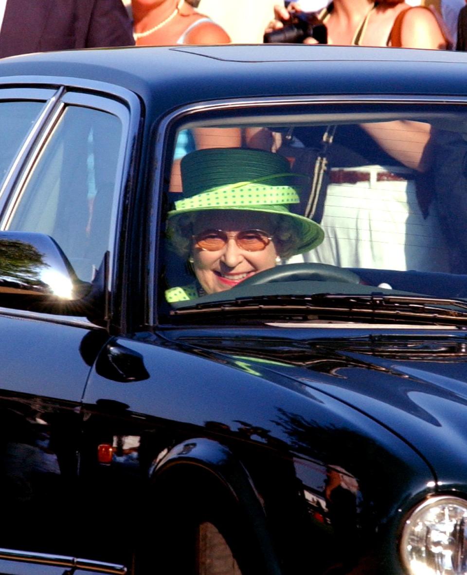 <p>Wearing a Kelly green hat, the Queen sat behind the wheel, headed to a polo match at the Guards Polo Club. </p>