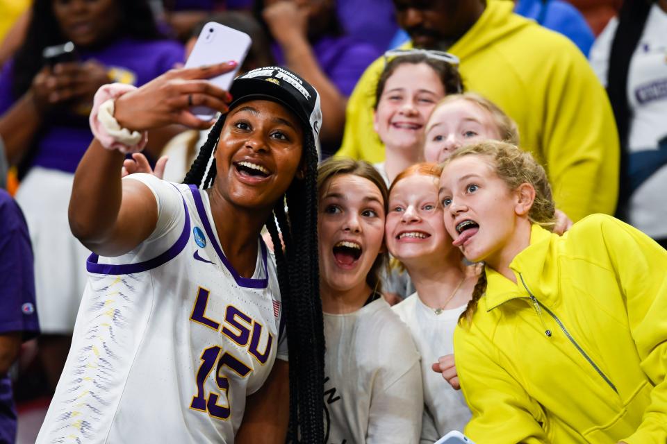 LSU's Alisa Williams (15) takes a selfie after the Tigers won their Elite Eight game on March 26, 2023.