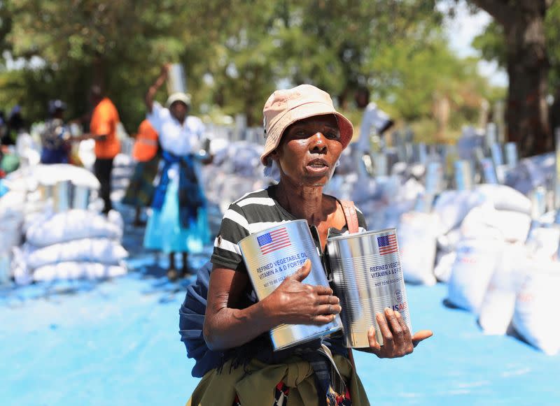 Villagers collect monthly allocations of food aid provided by WFP in Mumijo