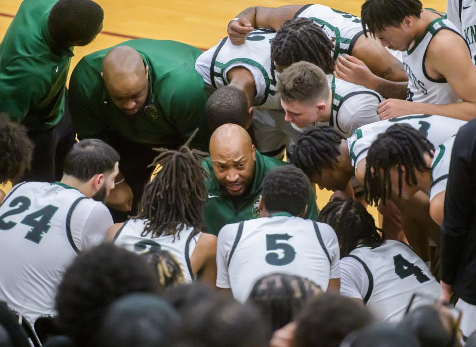 Richwoods players huddle around head coach William Smith during a timeout in the second half of the Class 3A Boys Basketball Peoria Regional semifinals Wednesday, Feb. 22, 2023 at Peoria High School. The Knights defeated the Peoria Notre Dame Irish 51-40.