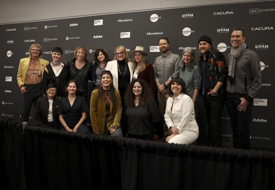 The director, producers, co-producers and Emily Saliers and Amy Saliers, fourth and fifth from the left rear, of the Indigo Girls pose for photos at the premiere of their documentary film “It’s Only Life After All” at the Ray Theatre in Park City on Thursday, Jan. 19, 2023. | Laura Seitz, Deseret News