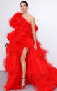 Dua packs on the featers in her fiery red tiered one-shoulder Valentino Haute Couture gown with de Grisogono jewelry at the amfAR Gala.