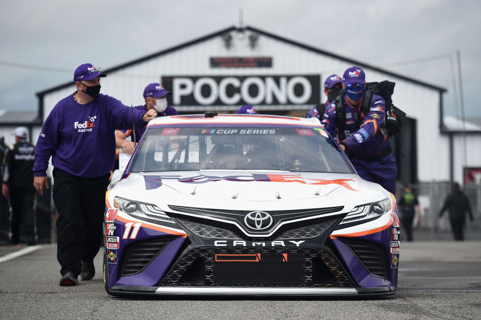 LONG POND, PENNSYLVANIA - JUNE 27: The crew pushes the #11 Toyota FedEx Ground, driven by Denny Hamlin, onto the grid prior to the NASCAR Cup Series Pocono Organics 325 in partnership with Rodale Institute at Pocono Raceway on June 27, 2020 in Long Pond, Pennsylvania.  (Photo by Jared C. Tilton/Getty Images)