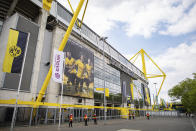 Security stuffs stand outside the stadium prior to the German Bundesliga soccer match between Borussia Dortmund and FC Schalke 04 in Dortmund, Germany, Saturday, May 16, 2020. The German Bundesliga becomes the world's first major soccer league to resume after a two-month suspension because of the coronavirus pandemic. (Guido Kirchner/dpa via AP)