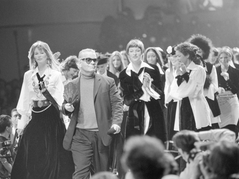 Karl Lagerfeld surrounded by models walks down the cat walk at Chanel fashion show