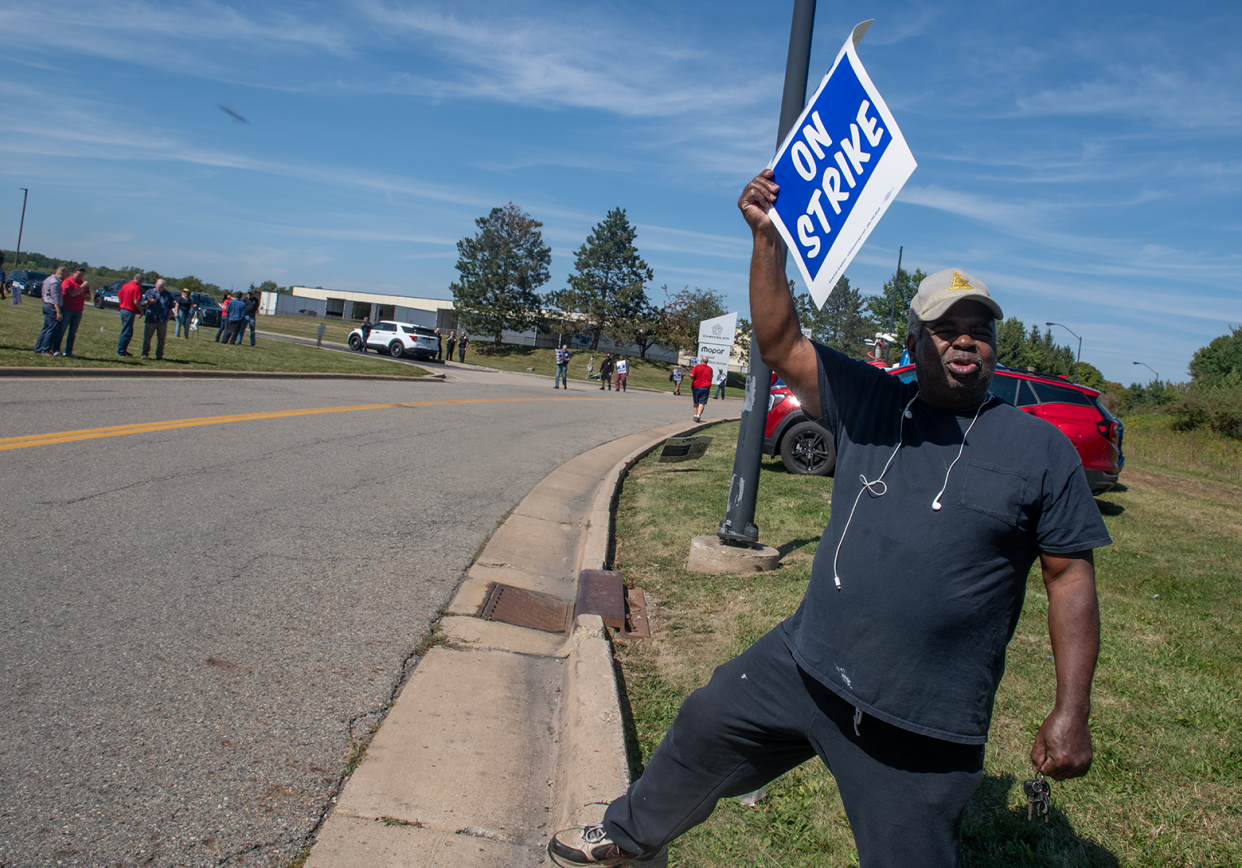 United Auto Workers union member Kenny Henderson holds a strike sign at a Stellantis parts distribution center in Streetsboro on Sept. 22.