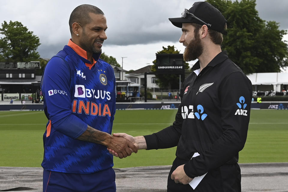 Captains of India Shikhar Dhawan, left, and New Zealand Kane Williamson shale hands before their one day international cricket match in Hamilton, New Zealand, Friday, Nov. 25, 2022. (Andrew Cornaga/Photosport via AP)