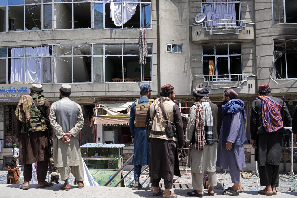 File - Taliban fighters gather at the site of an explosion in front of a Sikh temple in Kabul, Afghanistan, Saturday, June 18, 2022. (AP Photo/Ebrahim Noroozi, File)