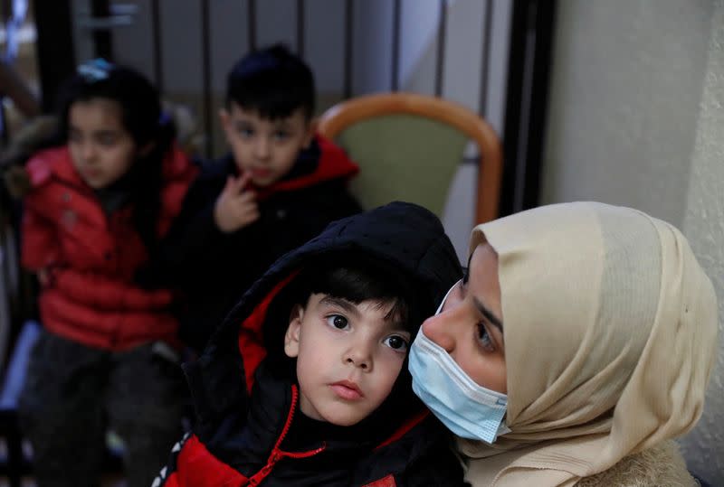 Ali, a 4 years old boy from Syria waits with his mother at a police registration centre in Nitra