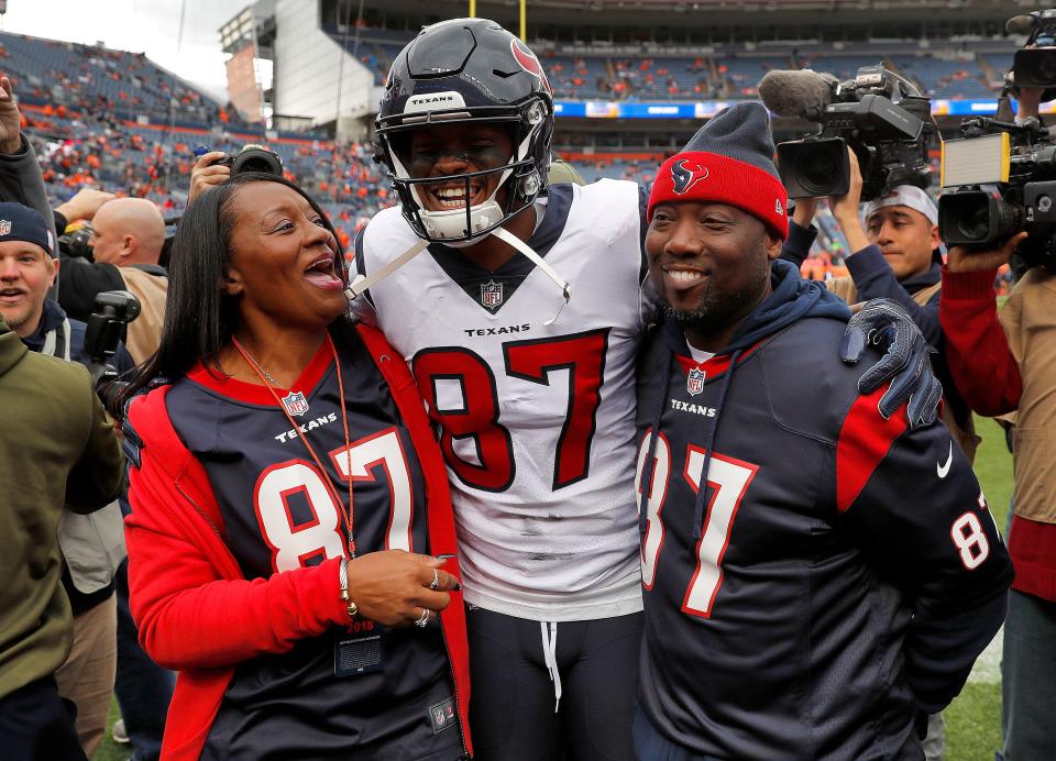 Demaryius Thomas stands with his parents, Bobby Thomas, right, and Katina Smith, prior to the team's NFL football game against the Denver Broncos on Nov. 4, 2018, in Denver.
