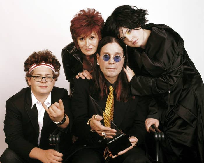 The Osbourne family posing together; two seated and two standing, in formal attire