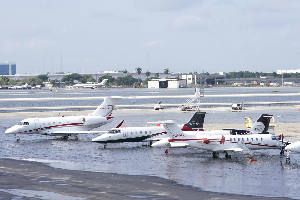 Small planes are parked at Fort Lauderdale- Hollywood International Airport, after the airport was force to shut down due to flooding, Thursday, April 13, 2023, in Fort Lauderdale, Fla. It's been a rainfall tale of two states in Florida this year, where the southeast coast has been inundated by sometimes-record rainfall and much of the Gulf coast is dry as a bone. (AP Photo/Marta Lavandier, File)