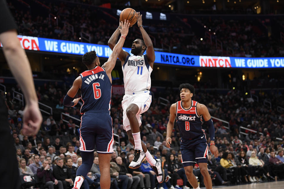 Dallas Mavericks guard Tim Hardaway Jr. (11) goes to the basket between Washington Wizards forward Troy Brown Jr. (6) and forward Rui Hachimura (8) during the first half of an NBA basketball game, Friday, Feb. 7, 2020, in Washington. (AP Photo/Nick Wass)